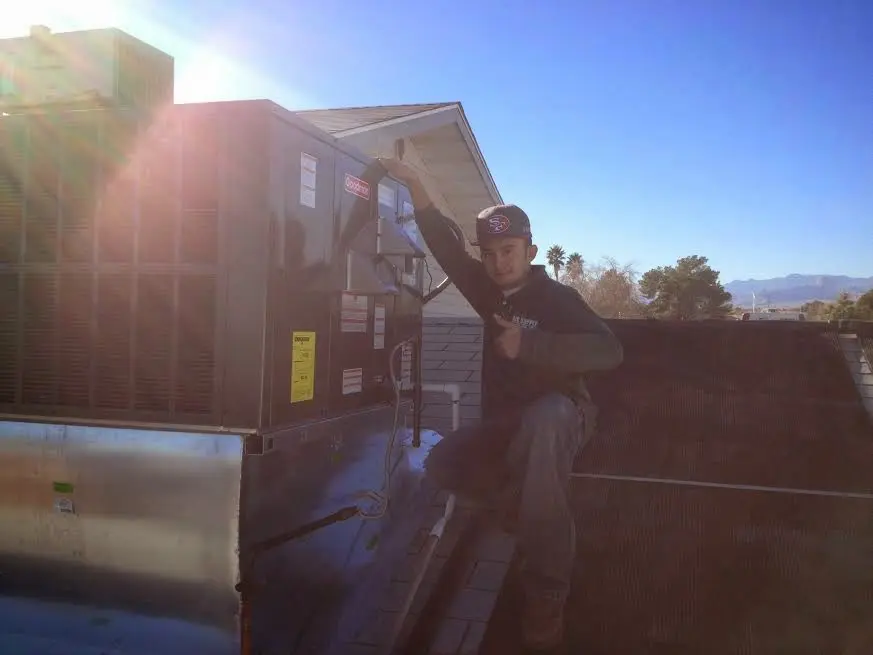 HVAC technician performing HVAC Inspection on a rooftop unit in Elko New Market